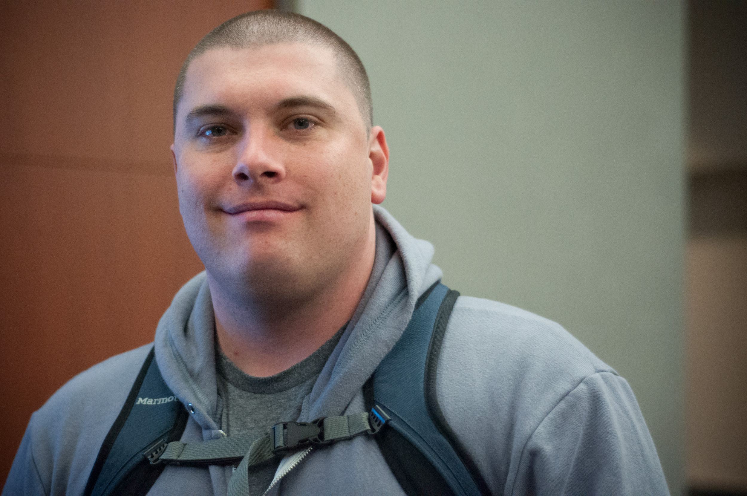 an image of jeff chandler wearing a blue hoodie while looking at the camera